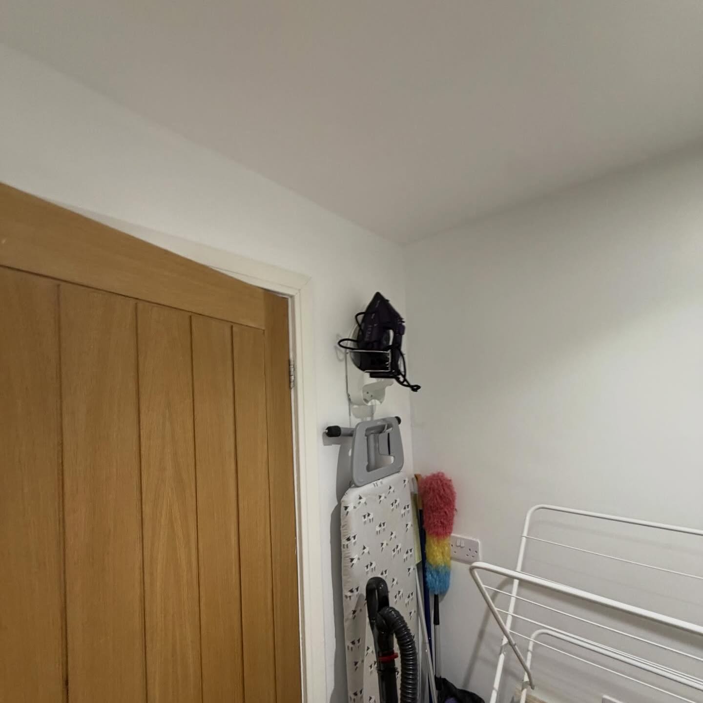 Hallway repainted in soft white around original oak doors