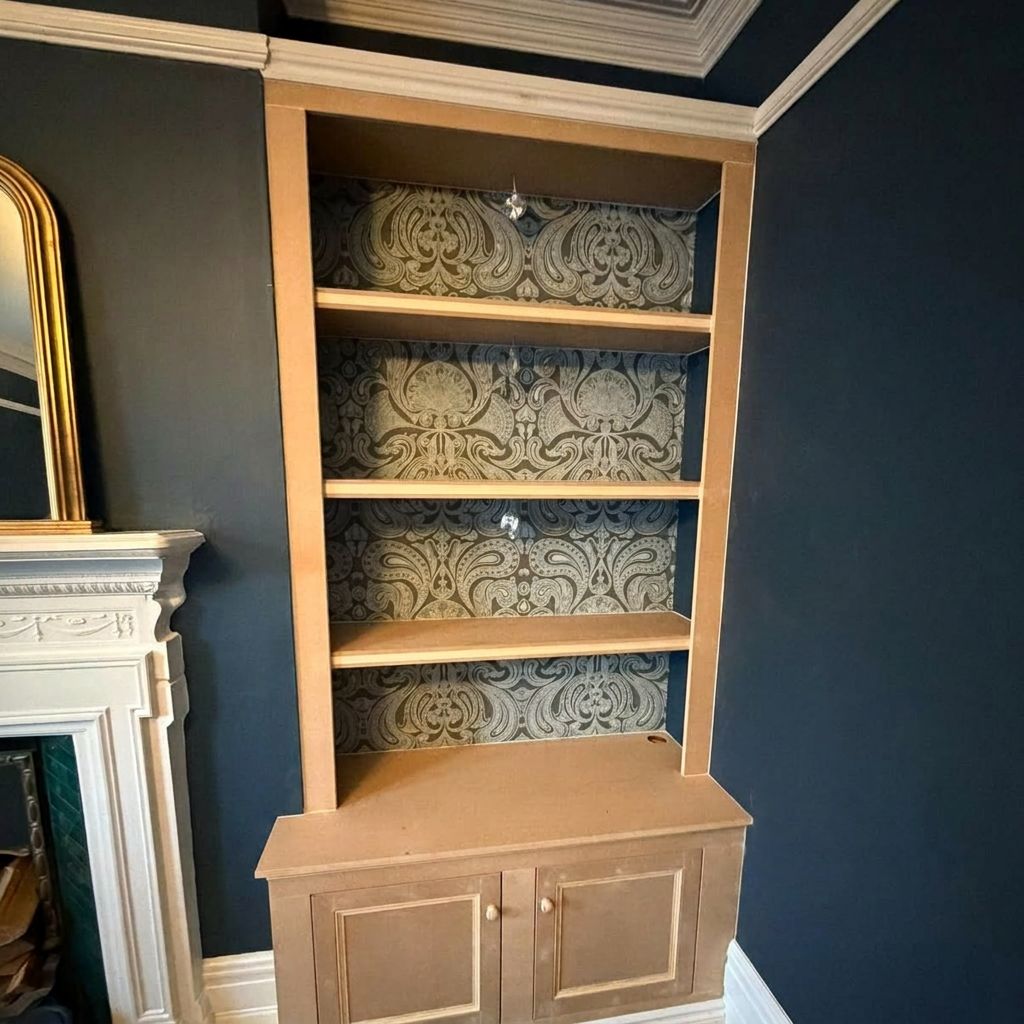 Alcove cabinetry in bare oak before hand-painting by That Paint Guy