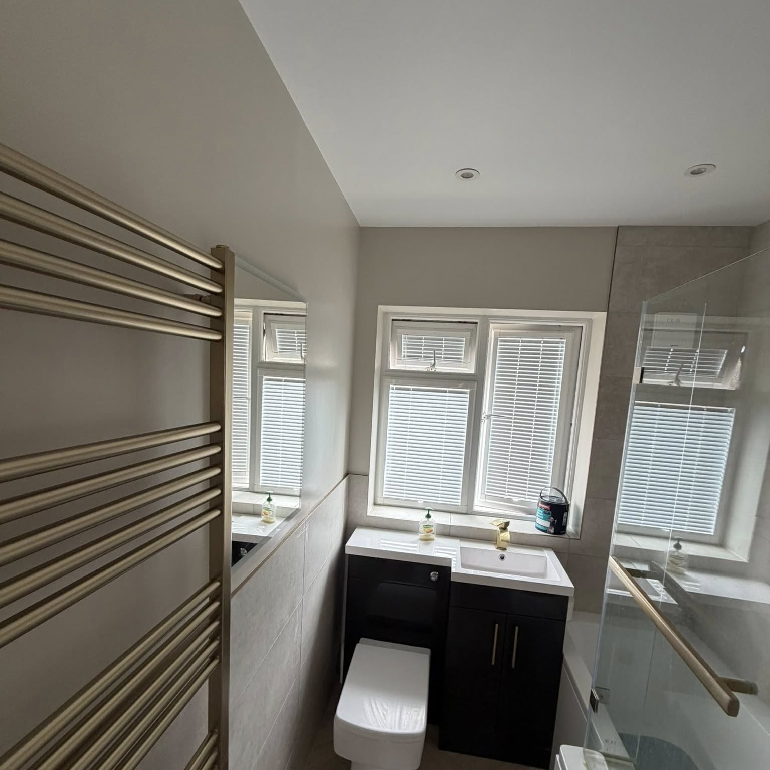 En-suite bathroom with freshly painted walls and chrome towel rail