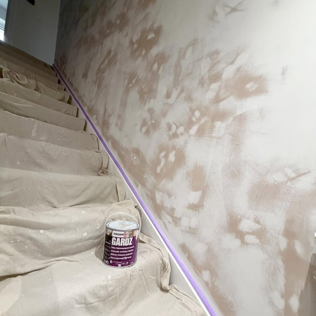 Staircase walls sealed and primed with surfaces protected by dust sheets