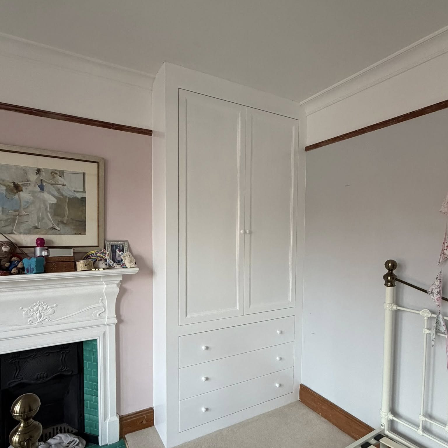 Corner shelving unit freshly painted as part of a soft pink room scheme