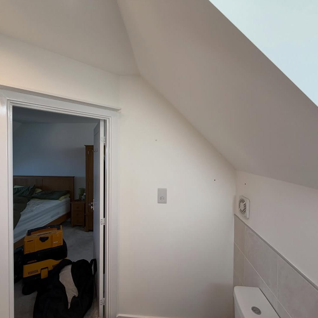 Loft bedroom eaves and walls freshly painted in soft white