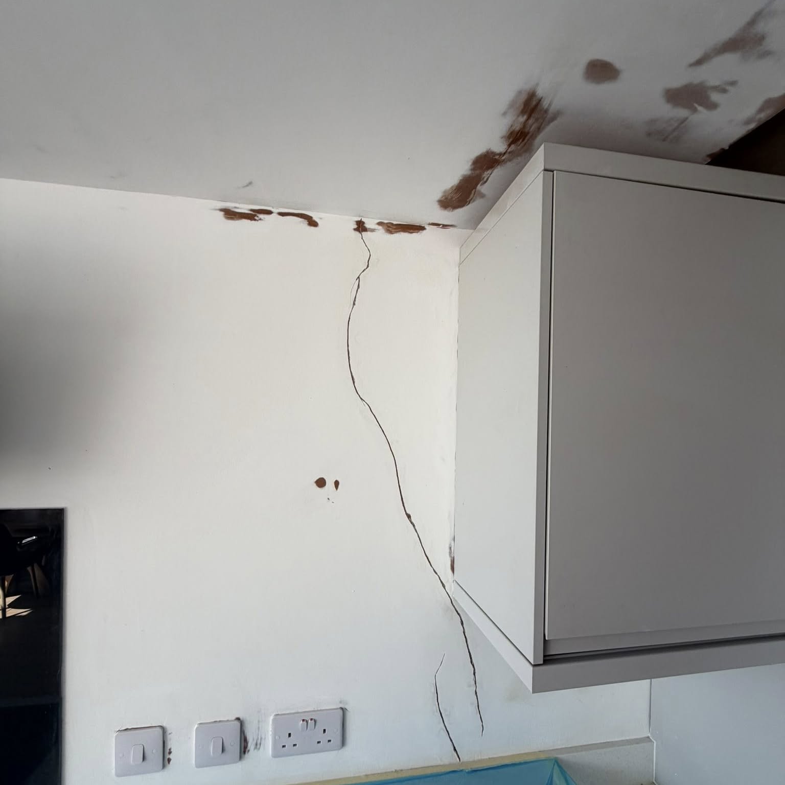 Cracked kitchen wall and ceiling ready for filling and repair